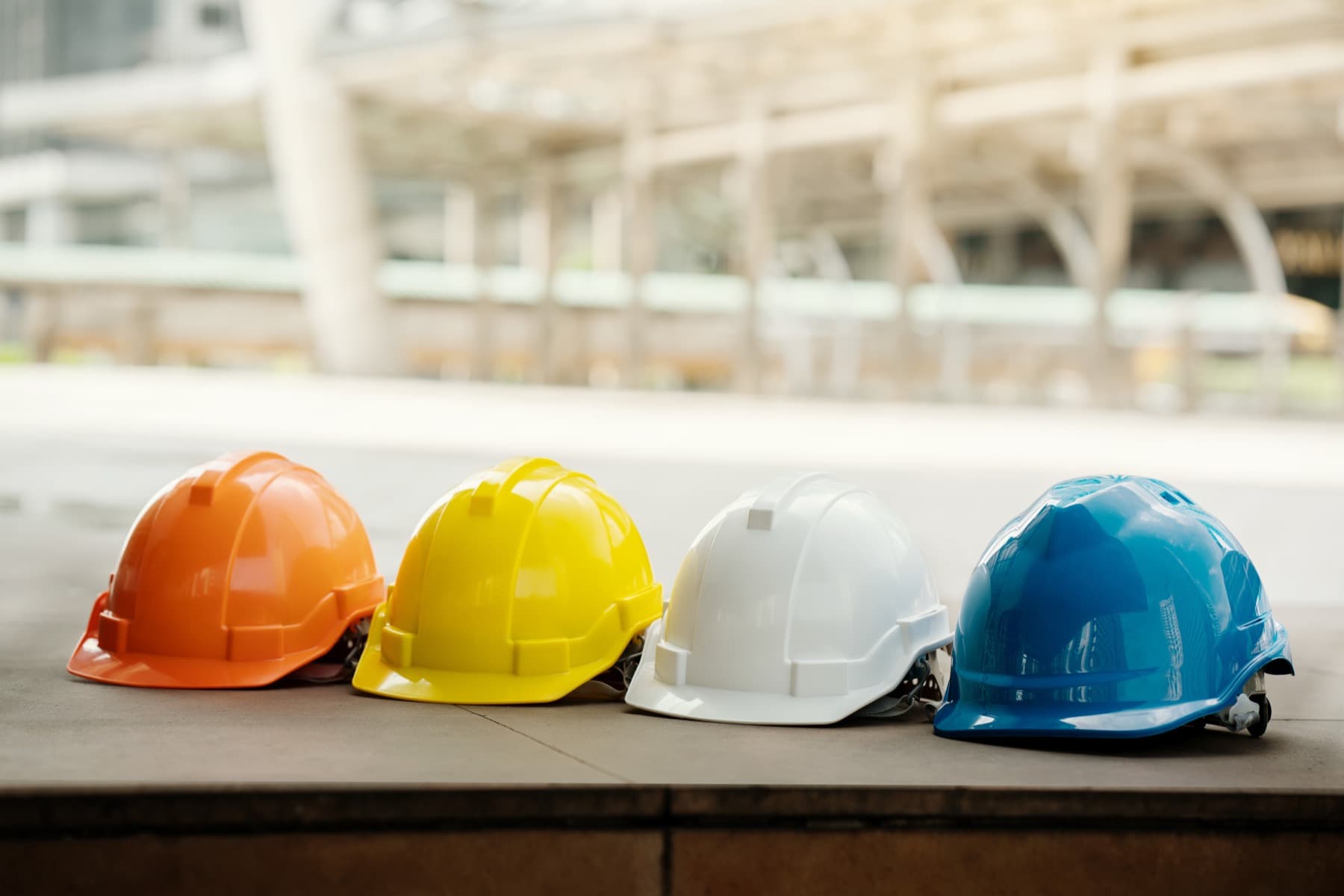 Row of industrial safety helmets on a construction site